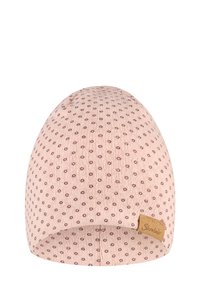 Light pink knitted beanie with small brown dots pattern and a small brown rectangular label on the rim.