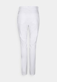 Pantalon blanc taille haute et coupe slim avec poches arrière, présenté de dos sur un fond clair uni.