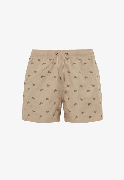 Costumi da bagno beige con vita regolabile tramite cordino, caratterizzati da un motivo a onde marrone scuro ripetuto. Realizzati in tessuto leggero con una texture liscia.