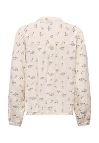 Blouse crème à manches longues avec imprimé floral bleu, tissu texturé, poignets boutonnés et détail de pli au dos
