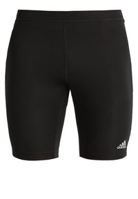 Pantalones cortos deportivos negros hechos de una tela elástica, con un ajuste ceñido, costuras planas y el logo de Adidas en blanco en la parte inferior izquierda.