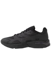 Black athletic shoes with a textured upper and smooth accents. Features a cushioned sole and lacing system for a secure fit.