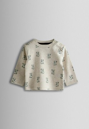 Lys grå langærmet skjorte med gentagne panda-designs. Blødt stof med rund halsudskæring og skuldertrykknapper.