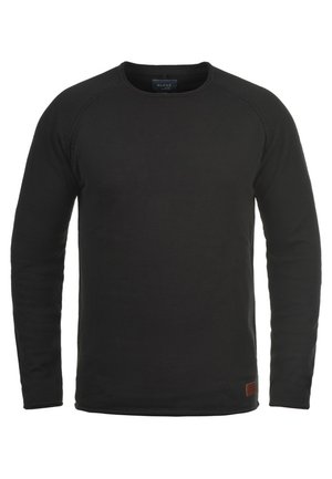 Black long-sleeve crew neck sweatshirt made of textured fabric with a small brown brand patch on the lower right side.