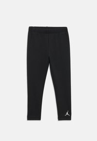 Μαύρα κολάν φτιαγμένα από μαλακό ύφασμα με ελαστική ζώνη στη μέση. Διαθέτουν το λευκό λογότυπο Jumpman στο κάτω αριστερό πόδι.