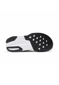Shoe sole featuring a black rubber outsole with geometric tread patterns, transitioning to a white midsole with textured surfaces.