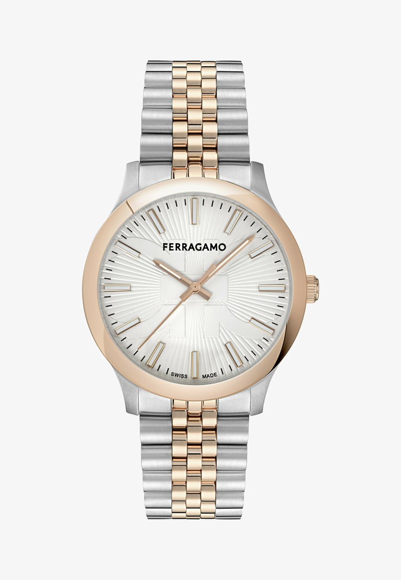 Dwukolorowy zegarek ze stali nierdzewnej w odcieniach srebra i złota, z białą teksturowaną tarczą, złotymi znacznikami godzin oraz różowozłotą lunetą. Nazwa marki wyraźnie widoczna.