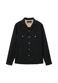 Sort langærmet skjorte med broderede detaljer på skuldrene, to brystlommer og firkantede sølvknapper ned foran.