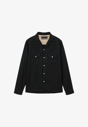 Zwart shirt met lange mouwen, geborduurde details op de schouders, twee borstzakken en vierkante zilveren knopen aan de voorkant.