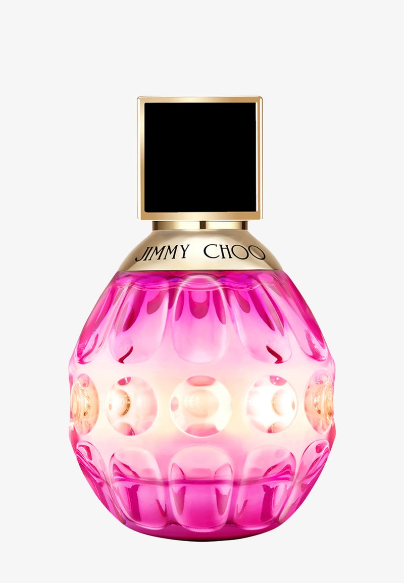 Pink faceted glass perfume bottle with gold collar engraved "JIMMY CHOO" and a large black square cap.