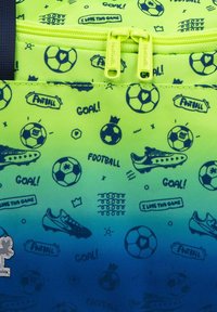 Sac à dos vert et bleu avec des motifs sur le thème du football, comprenant des ballons, des chaussures et du texte. En tissu durable avec des doubles zippers.