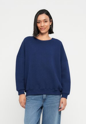 Marineblauwe sweatvest met een ronde hals, oversized pasvorm en lange mouwen. Gemaakt van zachte stof, met geribde manchetten en zoom.