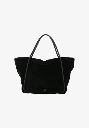 Black suede tote bag with two thin leather handles, soft texture, and a slouchy design. Notable gold logo accent near the base.