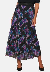 Black pleated maxi skirt with vibrant purple and teal floral print, featuring an elastic waistband and lightweight, flowing fabric.