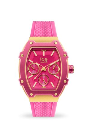 Rosa Gummiband-Uhr mit goldenen Akzenten. Achteckiges Gehäuse, drei Subdials und strukturierter Riemen. Auffälliges pinkes Ziffernblatt mit klaren Markierungen.