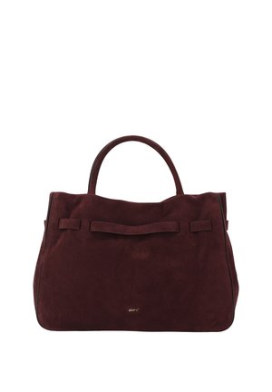 Dark brown suede handbag with two handles and a small gold logo on the front, set against a white background.