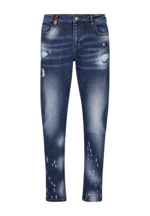 Jeans de mezclilla azul de corte ajustado con parches desgastados y decoloración. Cuenta con cinco bolsillos y cierre de botón. Tejido lavable a máquina.