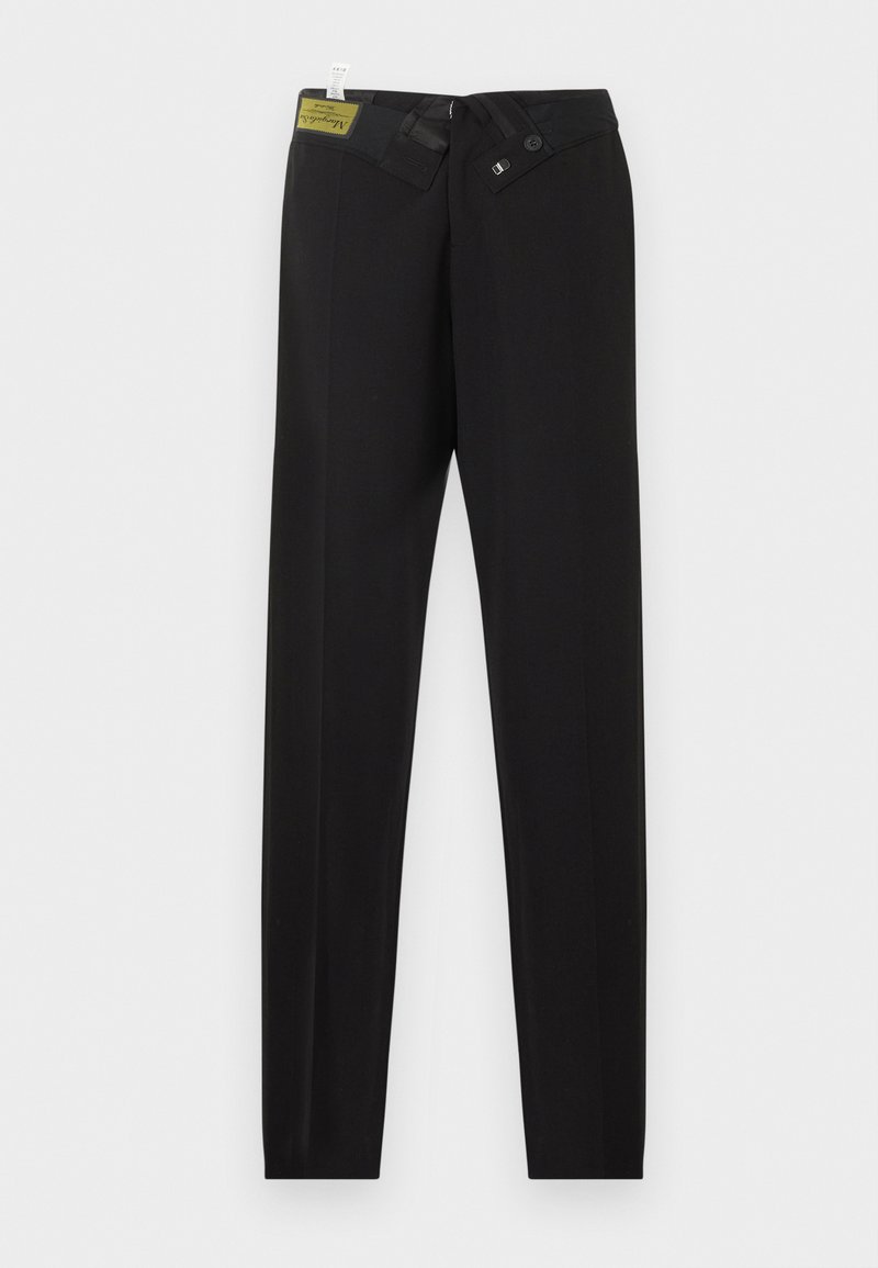 Pantalon noir sur mesure avec fermeture latérale à boutons et crochet, pli marqué le long des jambes, et une étiquette visible à l'intérieur de la ceinture.