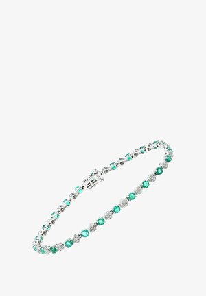 Broszka z zielonymi i przezroczystymi kryształami w metalowej srebrnej tonacji. Posiada naprzemienne okrągłe kamienie, kwadratowe akcenty oraz bezpieczne zapięcie.