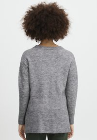 Langärmliger grauer Pullover mit strukturiertem Strick, geripptem Saum und weitem Ausschnitt, der einen lässigen Schnitt für zusätzlichen Komfort bietet.