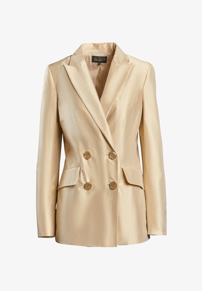 Beige színű, selyem anyagú dupla gombolású blézer, kihajtható gallérral, két elülső zsebbel és aranyszínű gombokkal a záródáshoz.