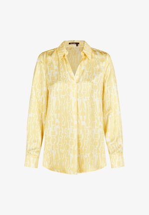 Long-sleeve yellow blouse with abstract light yellow and white pattern, pointed collar, and buttoned cuffs.