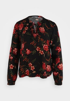 Zwarte blouse met lange mouwen en rood-oranje bloemmotief, ronde halslijn met strikkoordje en manchetten met knopen.