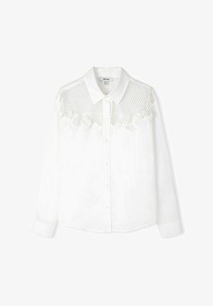 Chemise blanche à boutons, présentant un design en dentelle et en résille sur le haut devant, à manches longues et à col classique. Fabriquée en tissu léger.