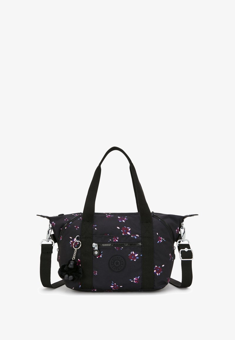 Svart tygväska med blommönster i lila och vitt, dubbla handtag, dragkedjefickor och avtagbar justerbar rem. Pyntad med en apa-charms.