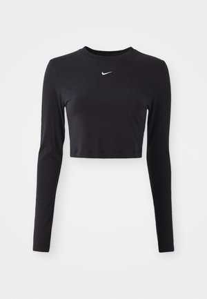 Svart langermet cropped topp laget av glatt stoff, med rund hals og en hvit Nike-logo på brystet.
