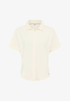 Polo manches courtes crème avec col, devant partiellement boutonné, et petit logo doré près de l'ourlet du côté droit.