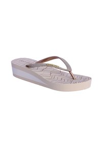 Chancla de plataforma color beige claro con suela texturizada, presenta una tira metálica bronce suave con acentos de purpurina y un logo en la plantilla.