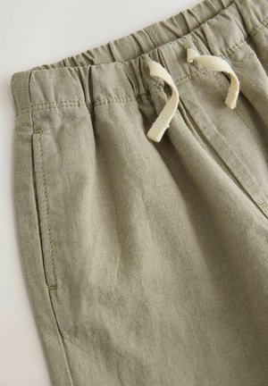 Beige linnen shorts met een elastische tailleband, voorzien van een trekkoord voor aanpassing en zijzakken. Zachte textuur met een ademende afwerking.
