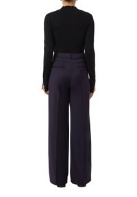 Black knit sweater paired with high-waisted, wide-leg trousers in dark purple, featuring side pockets and a tailored fit.