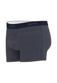 Boxers bleu marine avec un motif géométrique blanc, fabriqués en tissu doux. Comprend une ceinture solide avec le logo "Eminence".