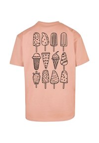 Peach short-sleeve t-shirt with a black graphic design of various ice cream cones and popsicles on the back; smooth cotton texture.