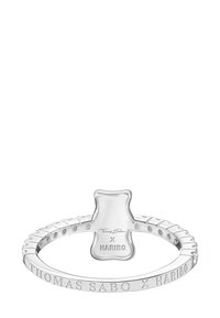 Silver ring featuring a bear-shaped accent, engraved brand names, and a textured band with a scalloped design.