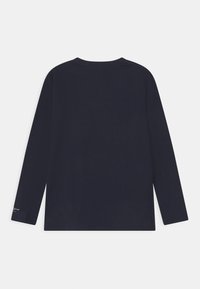 Navy long-sleeved t-shirt made from soft cotton. Features a simple crew neck and a subtle logo on the lower left sleeve.