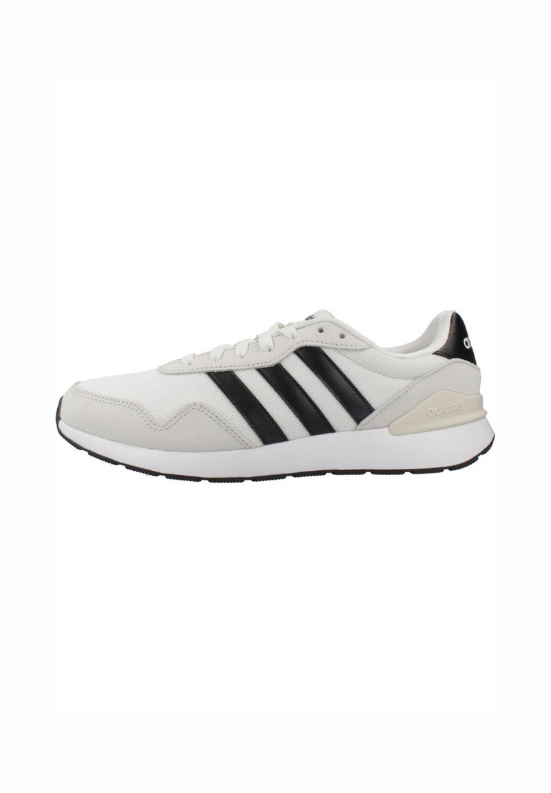 White athletic shoes with a textured upper, featuring three black stripes, a padded collar, and a rubber outsole.
