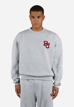 Gray cotton sweatshirt featuring a ribbed crew neckline, ribbed cuffs, and a maroon logo on the chest. Soft texture and relaxed fit.