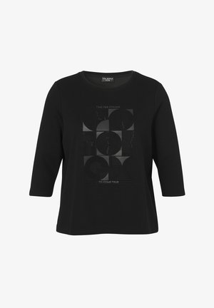 Chemise noire à manches longues avec motif géométrique de cercles et texte "Il est temps que les rêves se réalisent" imprimé au centre devant.