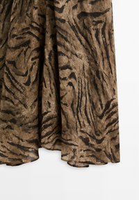 Tissu marron orné de rayures noires de tigre, présentant une texture douce. Le design crée une silhouette fluide avec des bords d'ourlet arrondis.