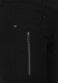 Black trousers with a smooth texture, featuring a side zip pocket with metallic hardware and a classic five-pocket design.