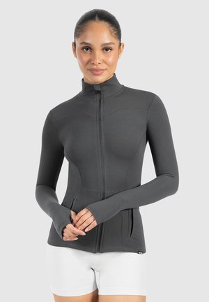 Dunkelgraue langärmlige Sportjacke mit hohem Kragen, Frontreißverschluss und zwei seitlichen Taschen. Hergestellt aus dehnbarem, glattem Stoff.