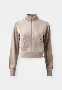Cropped beige zip-up jacket made of soft, velvety material with a high collar, front pockets, and elastic cuffs. Features small logo detail.
