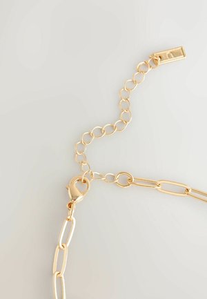 Kuldtooni ahel, millel on erineva kujuga lingid, varustatud loputuskraaniga ja reguleeritava ühendusega suuruse kohandamiseks. Sile, läikiv viimistlus.