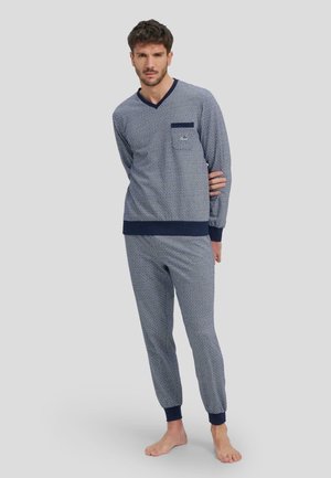 Conjunto de loungewear de rayas en azul marino y blanco con mangas largas y pantalones a juego. Presenta un escote en V y detalle de bolsillo en la camiseta.