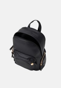 Black leather backpack with a rounded shape, gold zipper accents, front pocket, and a top handle for carrying. Textured finish.