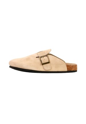 Beige suede slip-on clog with adjustable buckle strap, cork footbed, and black sole, designed for casual wear.