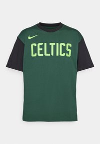 Camiseta de algodón verde con mangas negras, que presenta "CELTICS" en texto verde brillante. Incluye un logo de Nike en el hombro izquierdo.